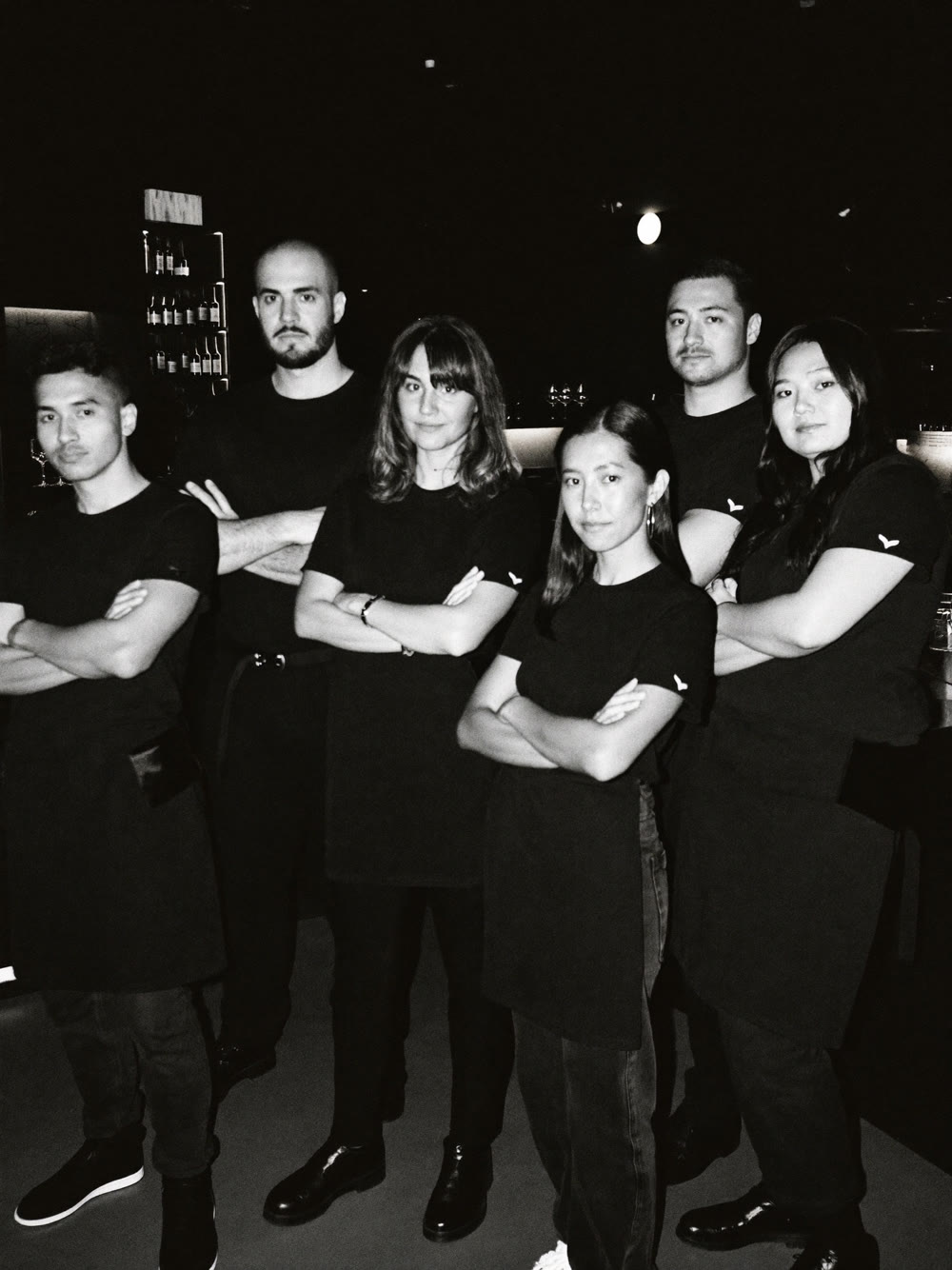 The Maestranza team in black, arms crossed
